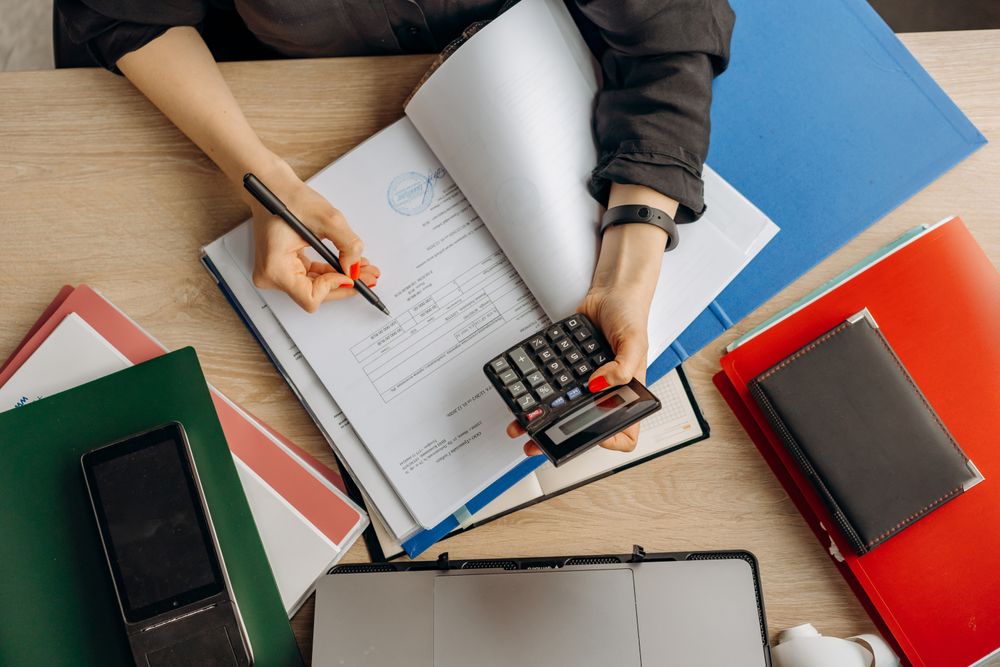 Home Compliance and payroll paperwork being reviewed on a desk