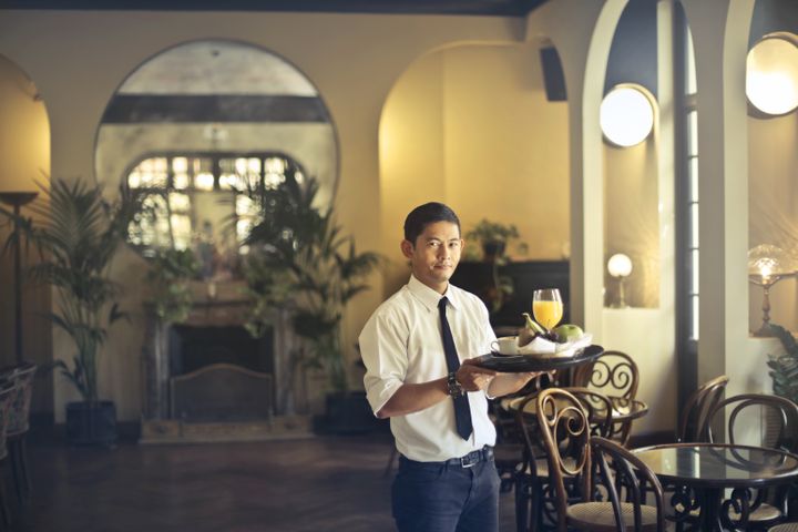 Home Waiter serving guests in a restaurant