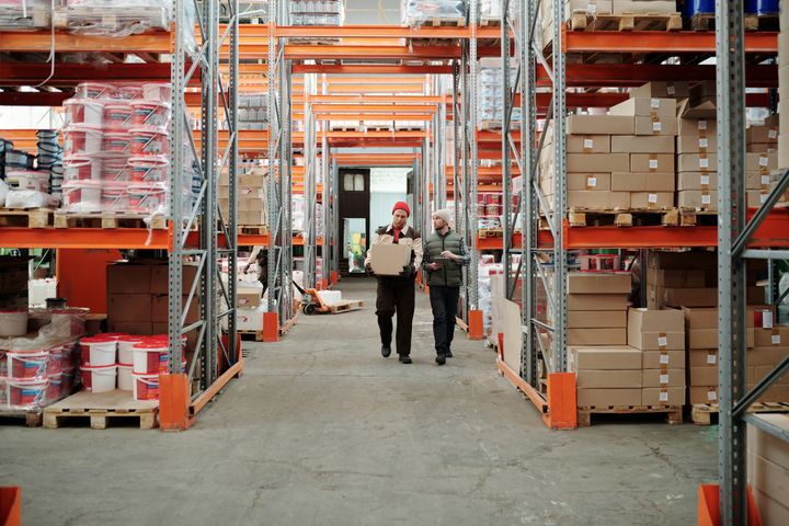 Home Workers walking along a warehouse aisle
